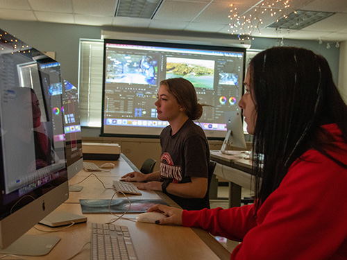 multimedia students working on a video project in adobe premiere pro