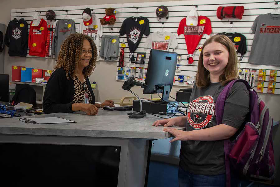 Smiling student at the counter of the bookstore