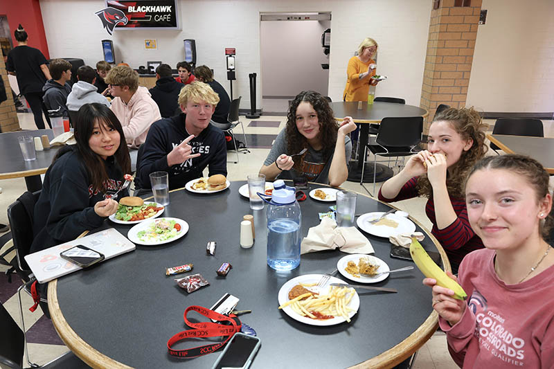 Students smiling and eating lunch