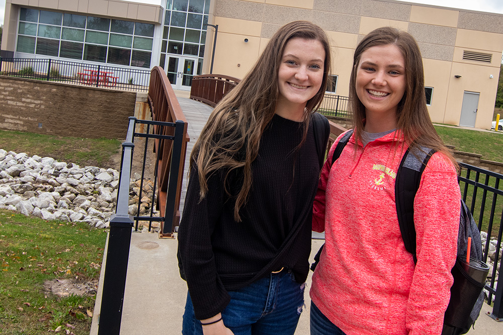 Two students smiling on bridge