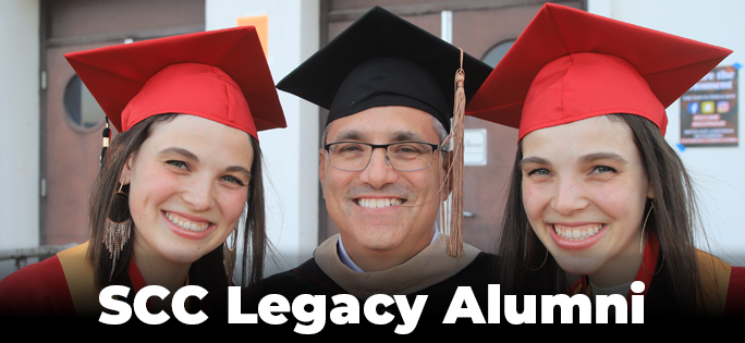 Smiling graduates with alumni