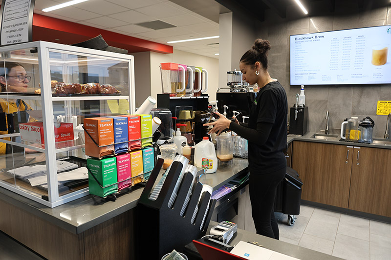 Woman serving coffee at keosk