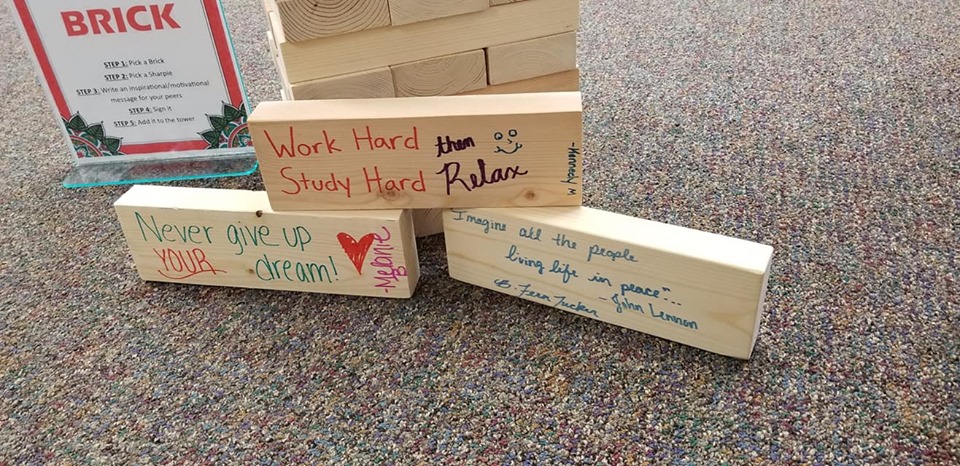 wood bricks with handwritten motivational messages "work hard study hard then relax, never give up your dream, Imagine all the people living life in peace - John Lennon