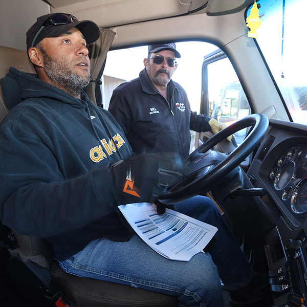 Two men in cab of semi truck