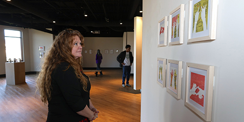 Woman admiring art in art gallery