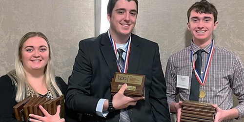 students with their awards at a business club competition