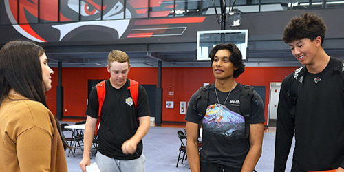 Students speaking with employer at career expo