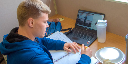 male student at a laptop