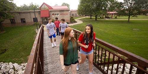 Students walking across bridge on Keokuk campus