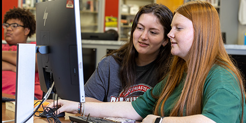 two female students in the library