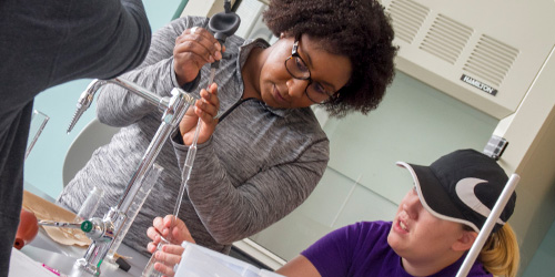 students measuring liquids