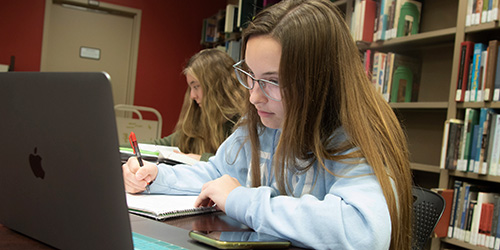 female student working on her laptop