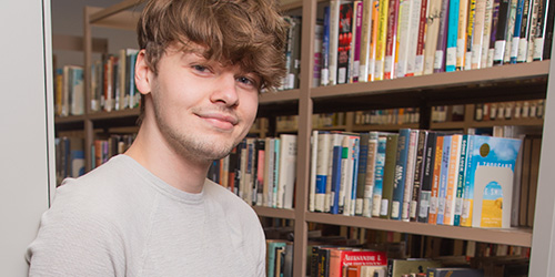 male student in the library