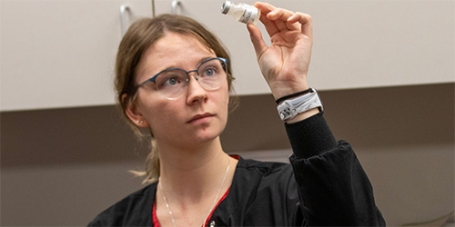 Nurse examining a specimen