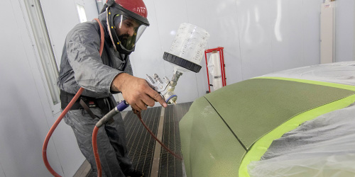 Student painting a car