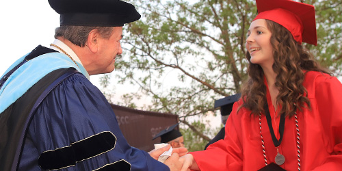 SCC president congratuates a female graduate