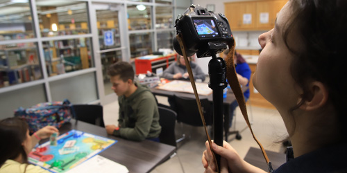 student using a camera during a video shoot