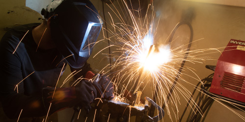 Welding student working on a project