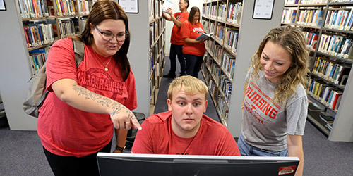 Students looking at a monitor
