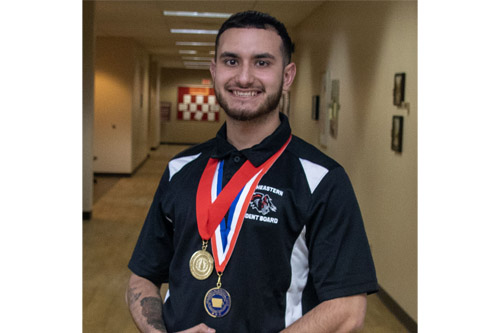 SCC student smiling with awards