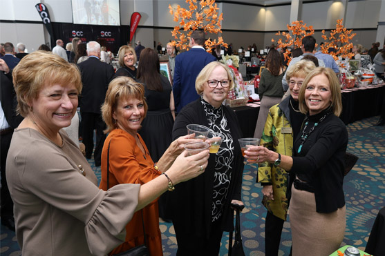 Smiling women raising glasses of wine