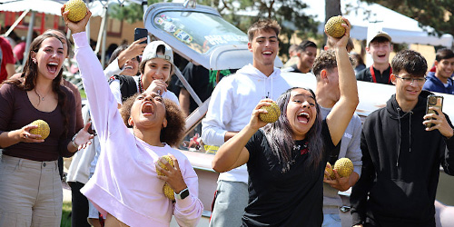 students throwing ball for dunk tank