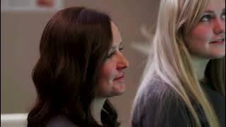 Student in blue scrubs smiling